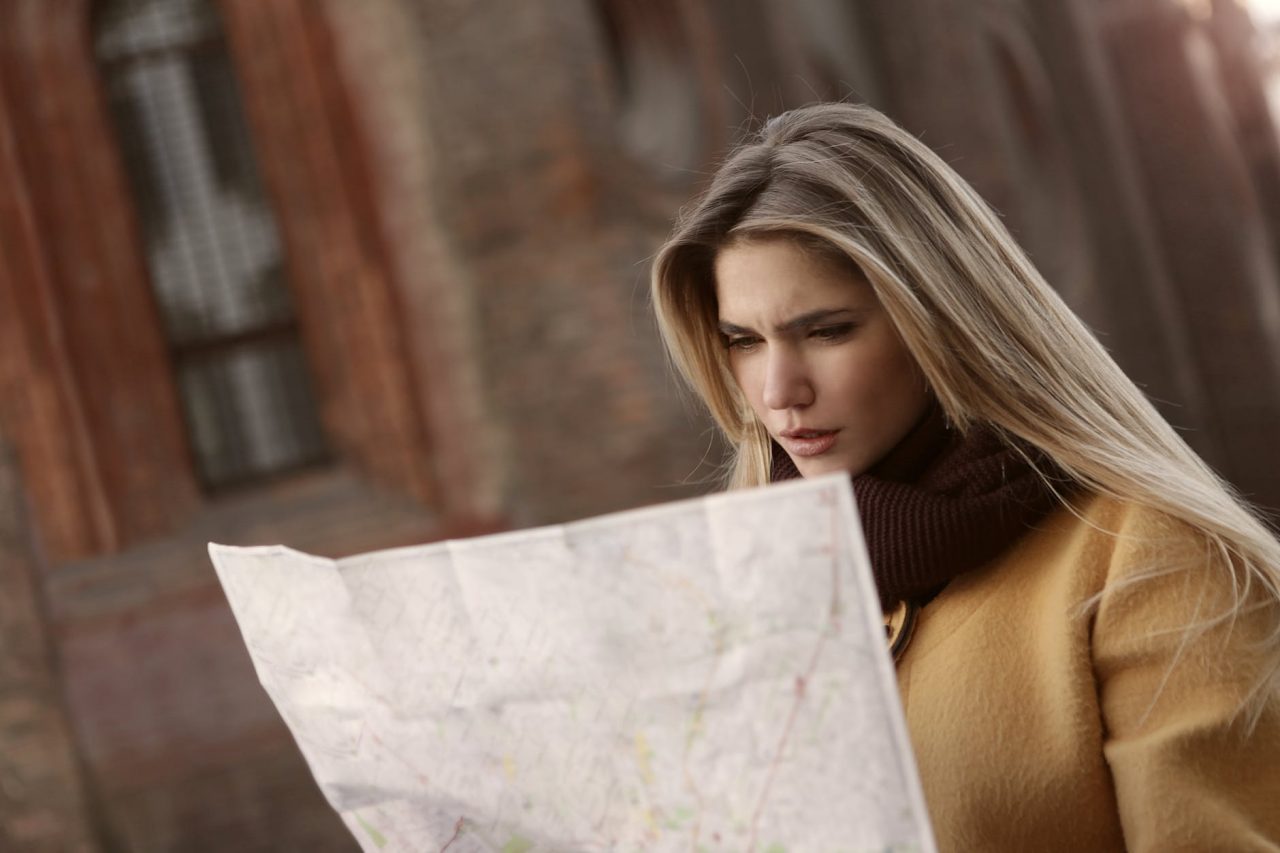 woman in brown long sleeve shirt holding map